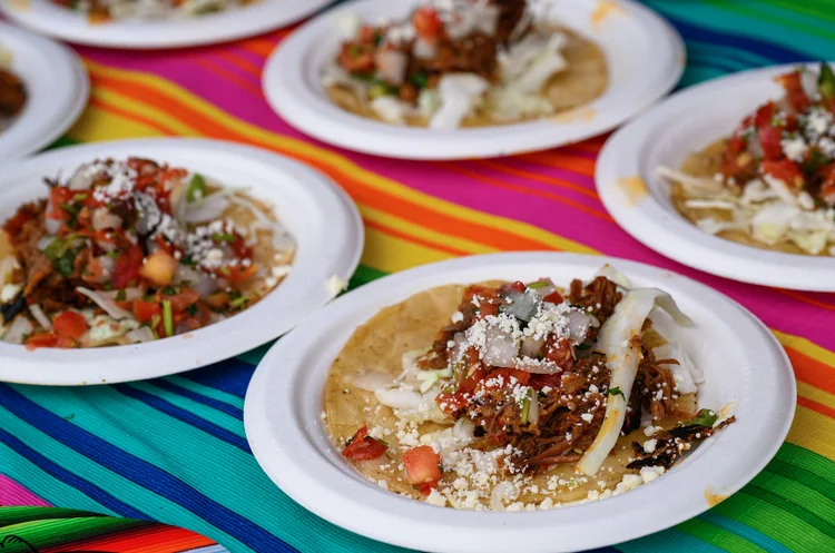 Street tacos on colorful plates at Boulder Taco Fest