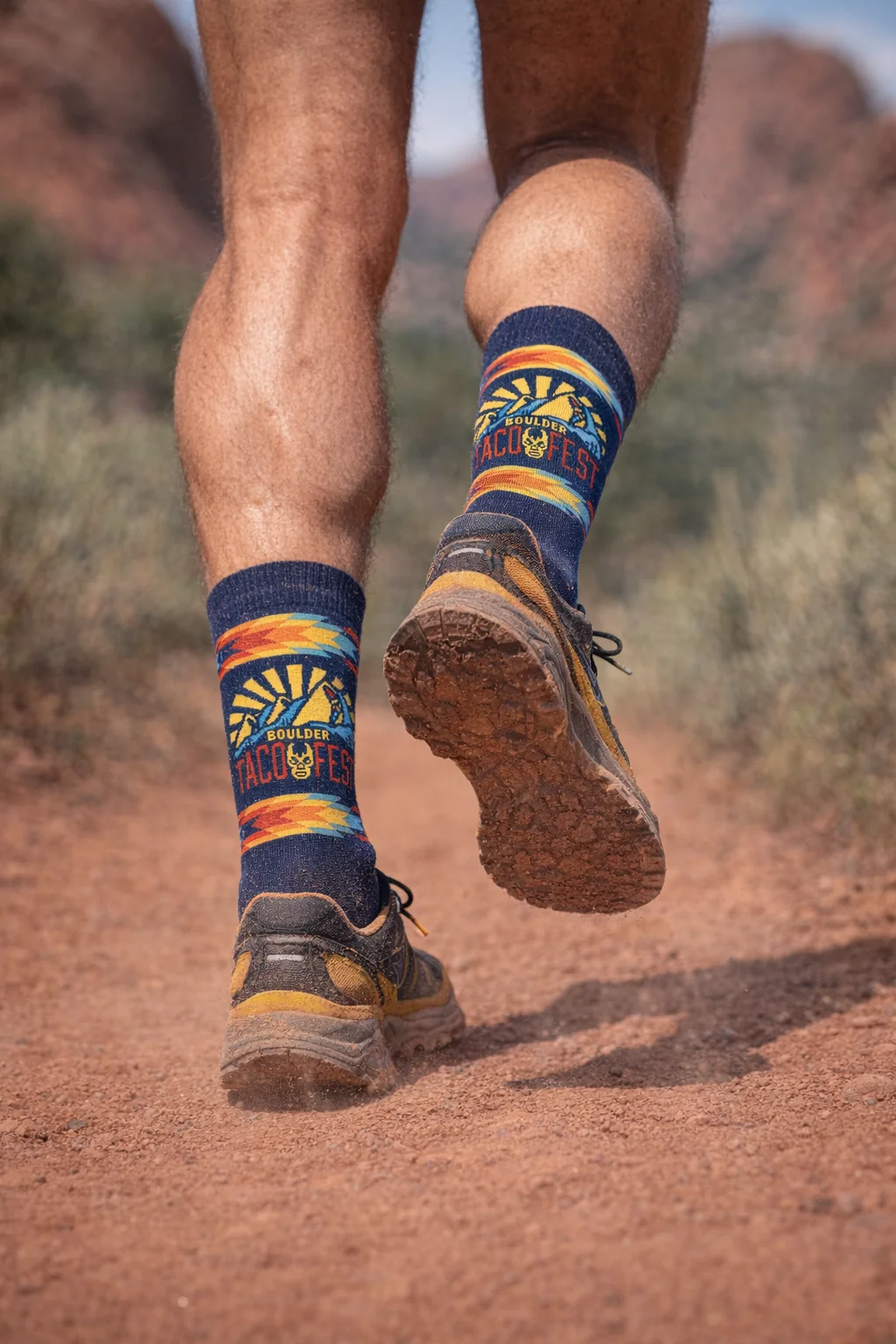 Runner wearing custom Boulder Taco Fest socks on a Colorado desert trail during the 5K Taco Run