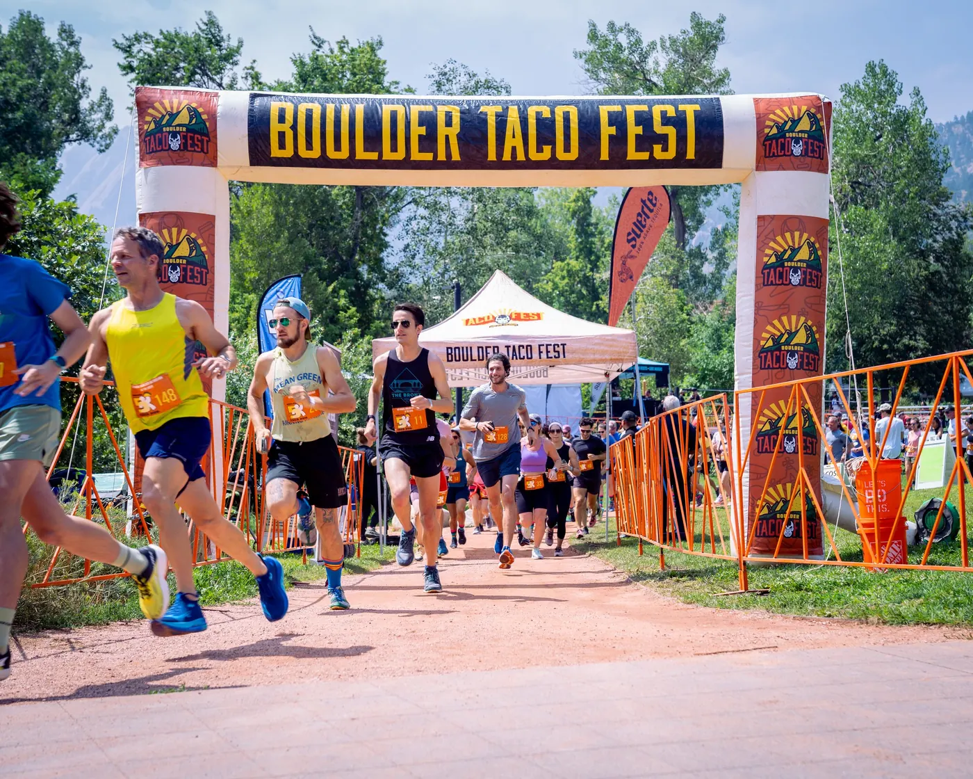 Runners crossing the start line at the Boulder 5K Taco Run
